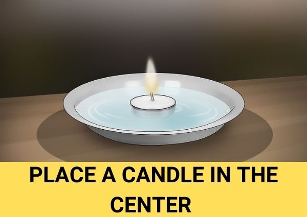 place a candle in the center of the dish soap flea trap